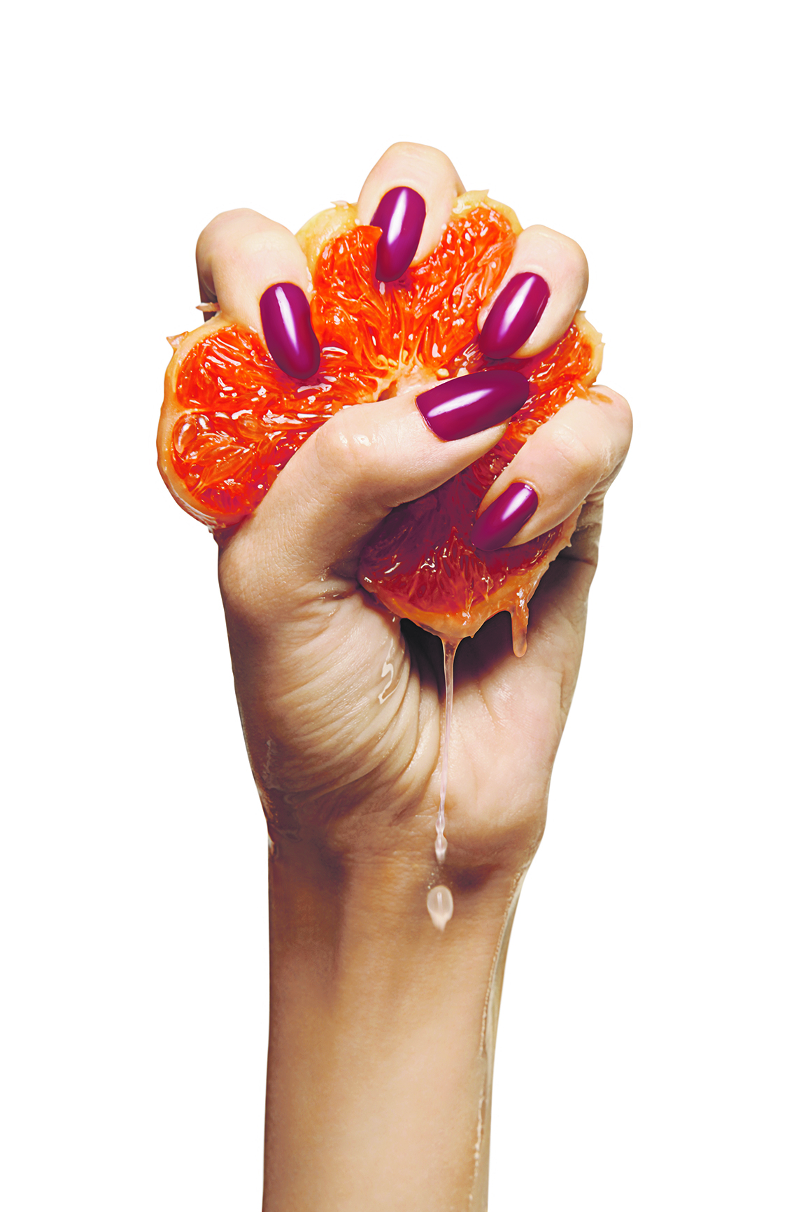 beauty female with purple nails squeezing grapefruit isolated